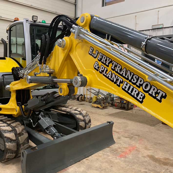 Excavator signwriting at M&M plant in Launceston